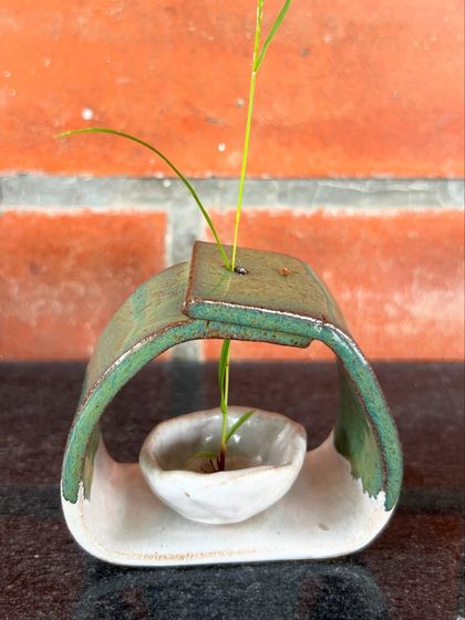 A unique, modern Ikebana-style vase made by Harshini. It’s designed to hold a single stem, showcasing the beauty of simplicity.