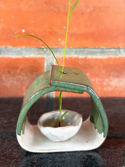 This unique, modern vase is a beautiful example of sculptural, functional art. It's designed to hold a single stem, making a minimalist statement.