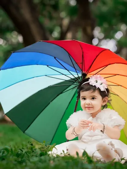 We take our creativity outdoors to the beautiful parks of Bangalore. This outdoor baby portrait uses natural light and a simple, colorful prop to create a dreamy and unforgettable image.