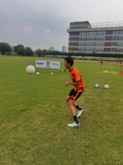 A player working on controlling the ball with his chest during a training drill.