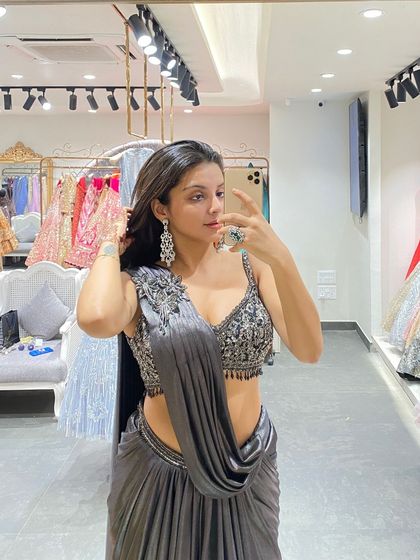 A close-up of the sparkling blouse and draped saree, a perfect combination for a Diwali party or cocktail event.