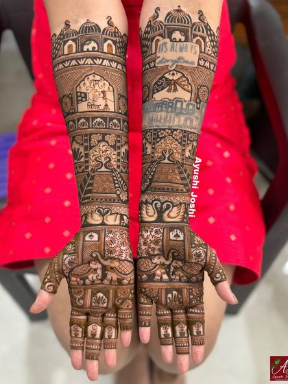 A clear, bright shot of the quote mehendi against a red dress, showing how the design stands out.