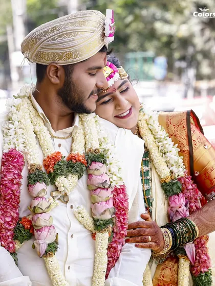 A tender moment between the bride and groom during their South Indian wedding ceremony. The bride rests her head on his shoulder, a quiet moment of comfort and love.