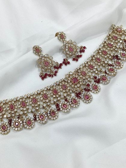 This choker set with deep ruby-red stones is a classic choice for brides and wedding guests. It pairs beautifully with traditional red or gold outfits.