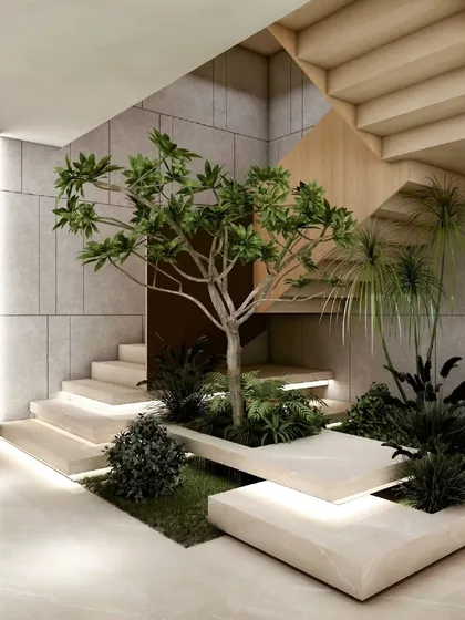 I believe transitional spaces should be experiential. Here, an indoor garden is integrated directly into the staircase, transforming the act of moving through the home into a moment of connection with nature. Backlit steps and raw concrete walls complete this serene composition.