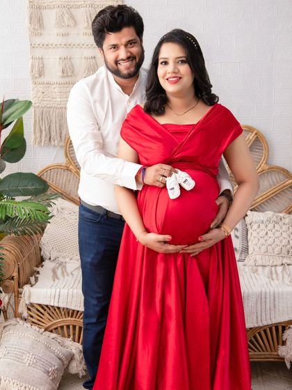 A beautiful portrait of the couple in our boho-chic setup. The husband's arm is wrapped lovingly around his wife as they both hold the baby bump, a symbol of their partnership.