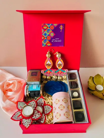 My classic Diwali box in red with a magnetic closure. This one is packed with chocolates, snacks, a decorative tin, and festive hangings.