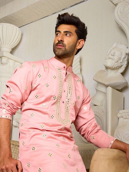 A relaxed pose in the pink kurta, showcasing its comfortable fit and elegant design. This piece is perfect for looking stylish with ease at any festive event.