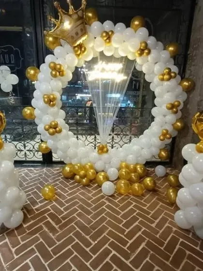 An elegant white and gold balloon ring with a crown on top. This royal-themed decoration is perfect for celebrating someone special in style.