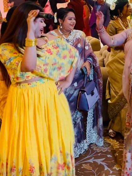 Dancing with the family members at an engagement party. It's a celebration, and I make sure to join in the fun.