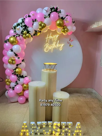 The full setup for the surprise birthday, with pedestals and a light-up name sign.