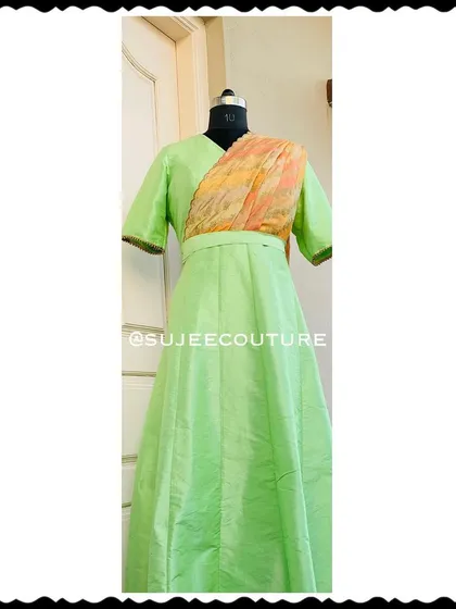 This full-length view shows a custom-made long gown in a lovely light green silk. I designed this piece with an attached, pre-draped dupatta in a contrasting print, so your little one gets a sophisticated look without any fuss. It’s a perfect example of a comfortable, one-piece occasion wear outfit.