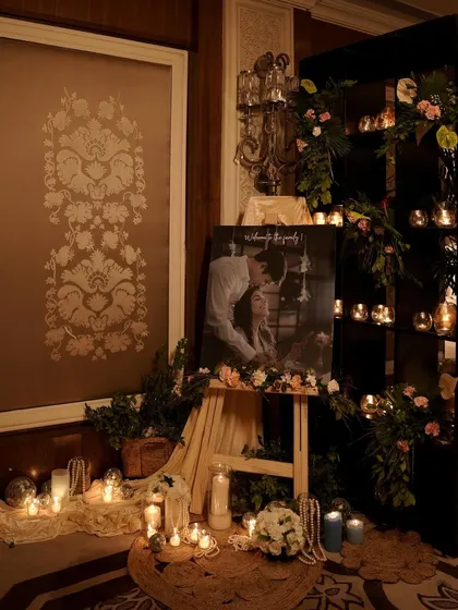 Personal touches make an event truly special. For this engagement, we created a beautiful, candlelit corner featuring a portrait of the couple, surrounded by pearls and delicate florals, to celebrate their story.