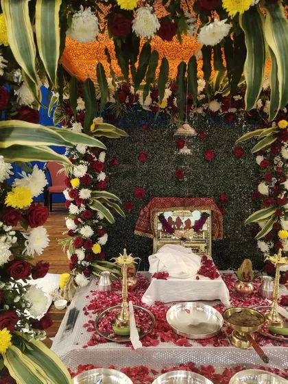 The beautifully decorated stage for a Rupaande Maa Pahedi performance at Yogi Sabhagrah. The sacred setup with flowers and the deity's image creates the perfect atmosphere for a night of devotion.