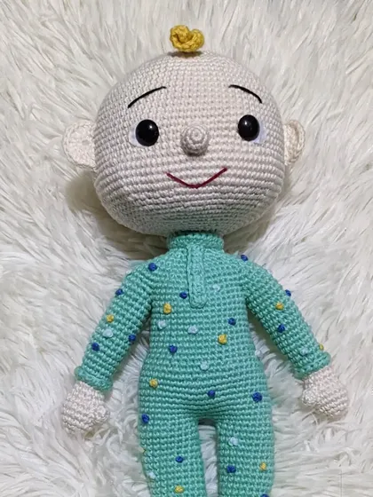 A different version of the JJ doll from Cocomelon, with slightly different facial features.