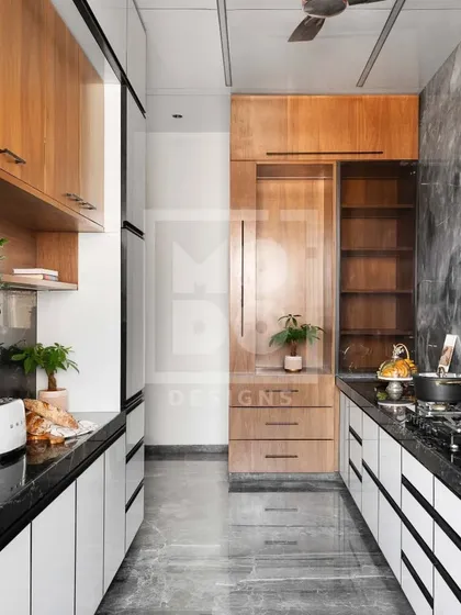 This galley kitchen is a masterclass in space optimization. We used a mix of wood and white cabinetry to create visual interest while providing extensive storage, including a full-size pantry and drawers.
