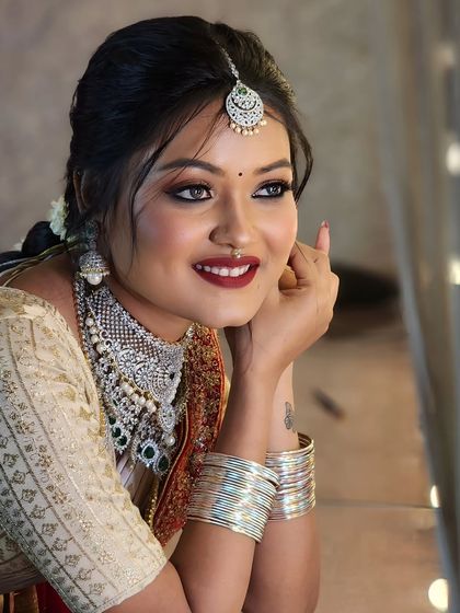 As pretty as a picture. This close-up shot showcases the flawless bridal makeup I created, with a bold red lip and defined eyes, complemented by stunning diamond jewellery.