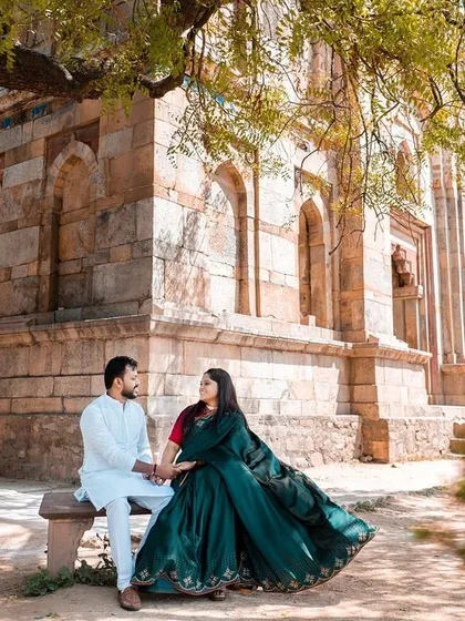 A serene portrait set against the backdrop of Lodhi Garden's beautiful architecture. The flowing green attire complements the natural surroundings, creating a picture of elegance.
