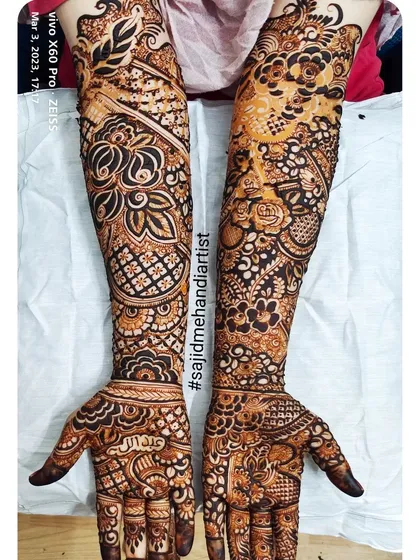 This is an example of extremely dense and detailed bridal mehandi, also known as "full-fill" style. Every inch of the skin is covered in intricate patterns, creating a very rich and opulent look.