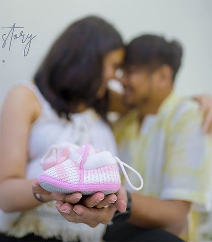 Our love story continues. Using simple props like a pair of baby shoes can tell such a powerful story, focusing on the new life and love the couple is bringing into the world.