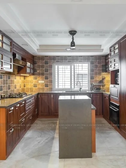 A wider view of the teakwood kitchen from image 20, showing the island and overall layout.