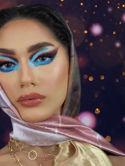 Bringing back the iconic 1950s headscarf era with a modern twist. This look features a bold, colorful eye that contrasts beautifully with the vintage styling.