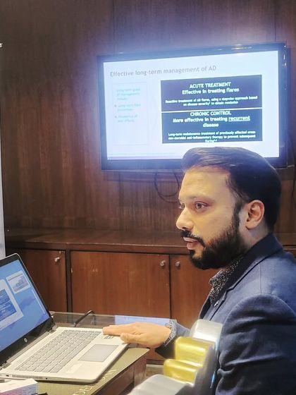 A candid shot of me during a presentation on the long-term management of Atopic Dermatitis. My goal is always to educate both patients and other doctors on the best practices for controlling chronic skin issues.