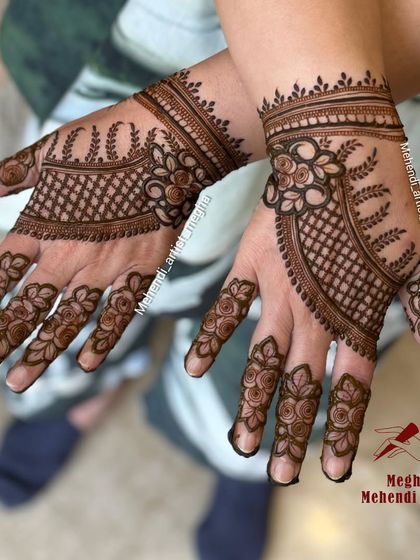 An elegant back-hand design with a net pattern cuff and delicate floral vines extending onto the fingers, creating a jewellery-like effect.