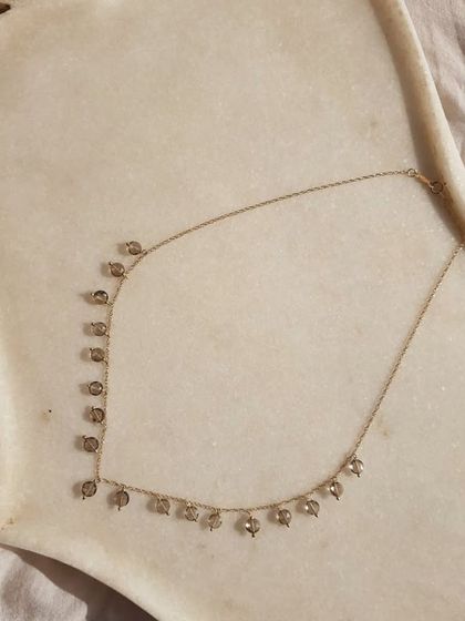 The 'hrasvá' Smoky Quartz Coin Choker, as seen on Sanya Malhotra. This grounding stone brings emotional calmness and relieves stress and anxiety.