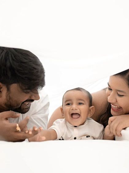 Pure joy. This candid shot of a family playing under a white sheet is full of laughter and genuine happiness.