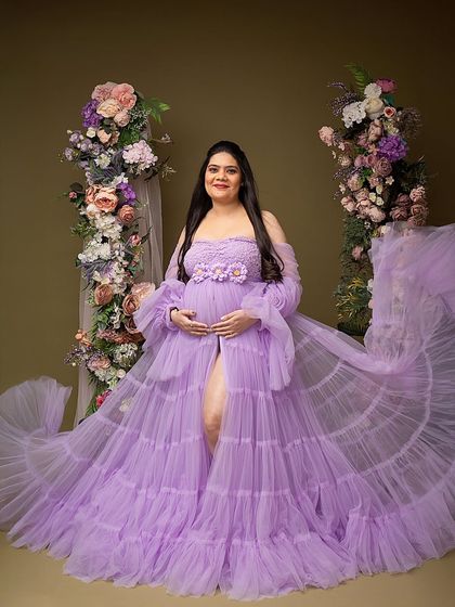 A confident and beautiful pose in a flowing lavender gown. The way the fabric is tossed creates a sense of movement and grace.