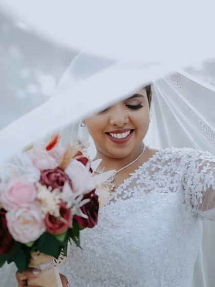 A similar take on the veiled bride, this image captures a slightly different angle of her joyful expression, showing the variety I provide within a single setup.
