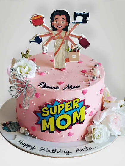 A "Super Mom" cake celebrating a mother who does it all. The topper shows her multitasking, and the cake is decorated with fresh flowers for an elegant touch.