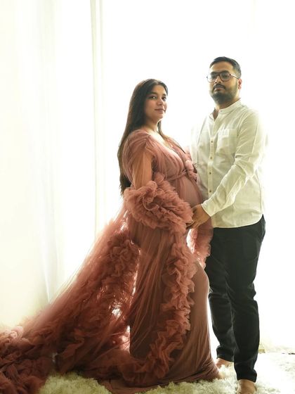This portrait showcases another of my beautiful maternity gowns. The soft pink tulle and high-key lighting create an ethereal and angelic look for the mother-to-be.