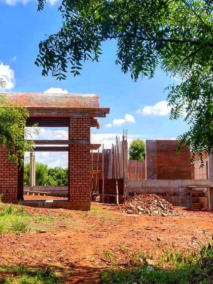 The "Elephants by the Lake" residence taking shape. This image captures the early stages of construction, with the brick framework rising amidst the natural landscape, promising a home that will be one with its surroundings.