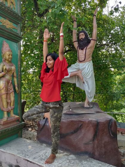 Twinning in Vrikshasana (Tree Pose) with a statue. It's a reminder to stand tall and find your balance in life.