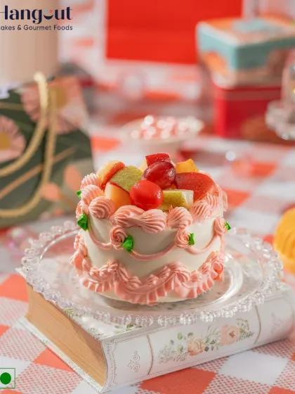 Bringing back the charm of vintage bakes. This fresh fruit bento cake is topped with a medley of seasonal fruits and decorated with dreamy pink swirls for a piece of edible nostalgia.