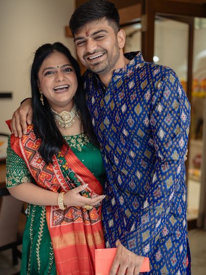 The brother and sister sharing a happy moment. For this event, we styled him in a striking blue patola print kurta, a nod to our shared Gujarati heritage and love for handloom textiles.