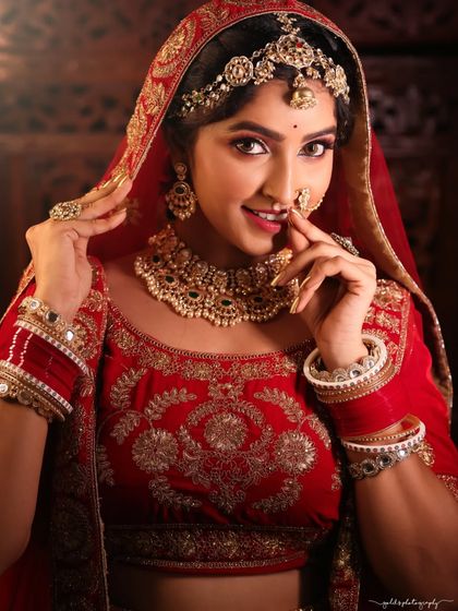 A series of portraits showcasing a model in a heavily embroidered red bridal lehenga. I focused on capturing the intricate details of the outfit and the flawless bridal makeup, presenting a look of regal elegance.