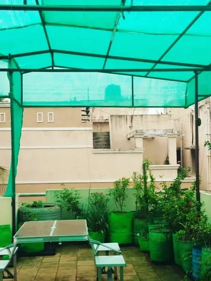 I can even set up a small seating area within your terrace garden. This setup includes a small table and chairs, making it a perfect spot to enjoy a morning coffee surrounded by your plants.