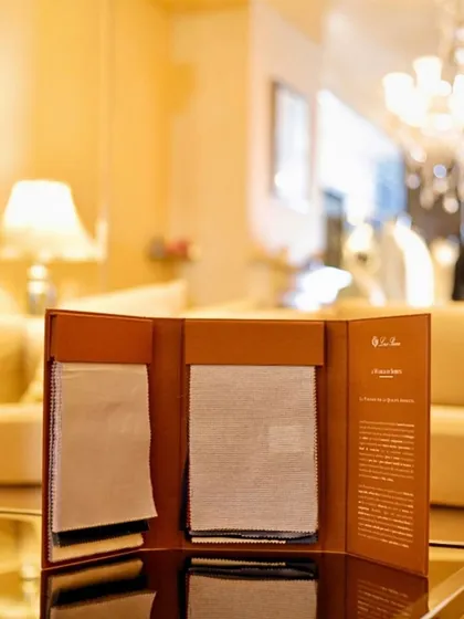 A Loro Piana fabric book displayed in our showroom. We are authorized dealers, ensuring authenticity and access to their latest collections.