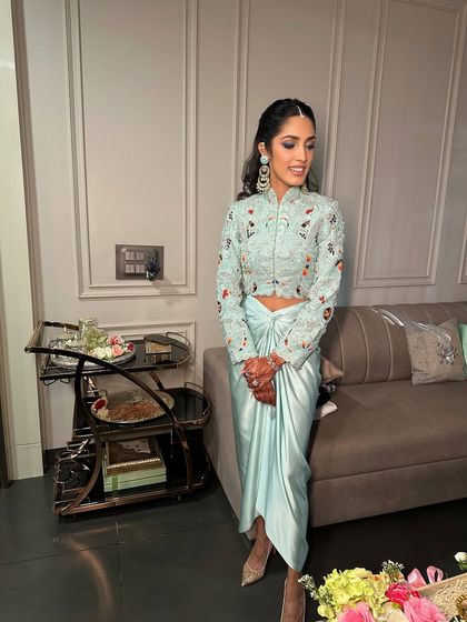 Blue never looked this soft, sultry, or spellbinding. This look for a modern bride features a defined eye and glowing skin to complement her unique Anamika Khanna outfit.