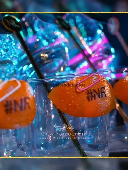 It's all about the personal touches. Here, we've transformed a simple orange peel into a custom drink tag, engraved with the couple's initials. This is the level of detail I bring to make your celebration truly yours.