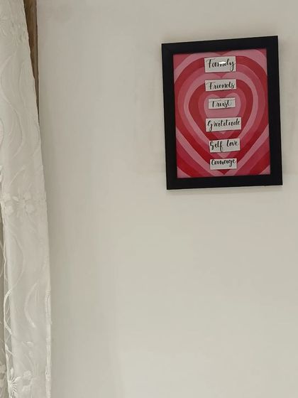 The final framed heart painting hanging on a wall, showing how my small art pieces can become meaningful home decor.