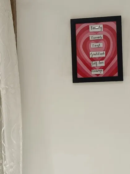 The finished heart-themed wall frame hanging in its new home.