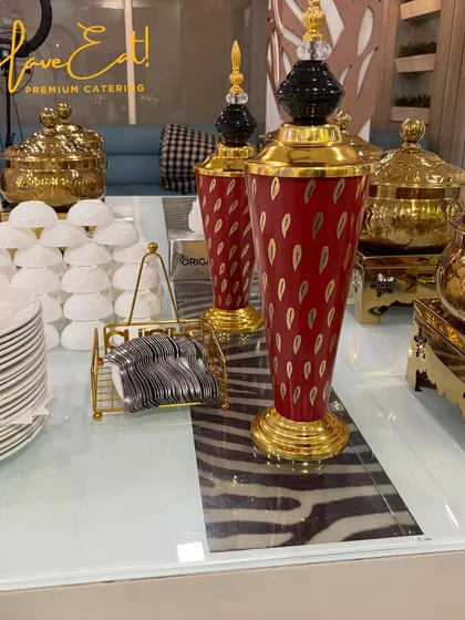 A close-up of the crockery station, featuring our decorative vases, stacked plates, and neatly arranged cutlery.