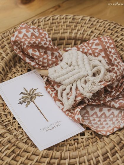 A custom-printed napkin and personalized welcome card featuring a palm tree, adding a thoughtful touch for guests at this destination wedding.