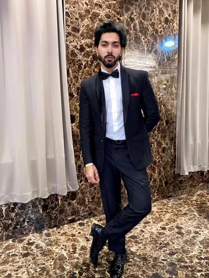 A classic and confident look. This client is rocking a timeless black tuxedo with a bow tie, a perfect rental for any formal occasion.