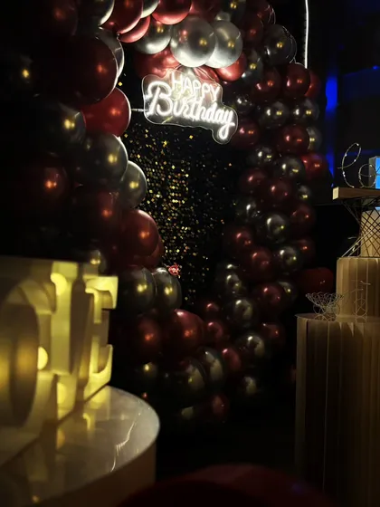 This angle shows how all the elements come together for a birthday party. You can see the balloon arch, neon sign, and marquee letters creating a festive corner in my private theatre.