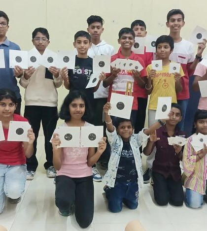 A full group photo of students and an instructor after a fun and productive workshop, with everyone holding up their practice targets.